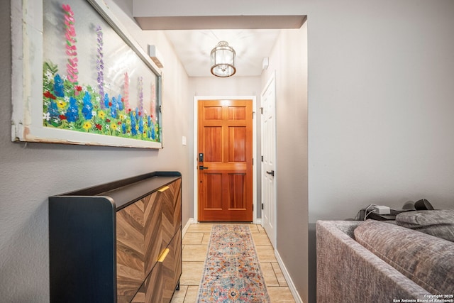 170 Pullman Rd, La Vernia, TX 78121 - doorway with an inviting chandelier, light tile patterned flooring, and baseboards