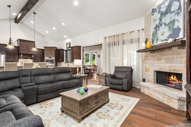 living room with recessed lighting, wood finished floors, beam ceiling, a fireplace, and high vaulted ceiling