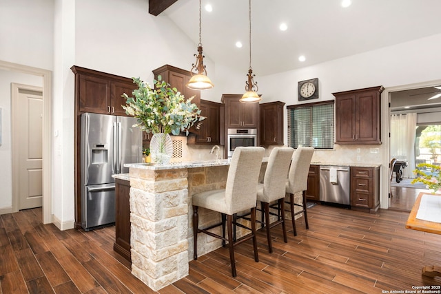 kitchen with dark brown cabinets, a center island with sink, high vaulted ceiling, and stainless steel appliances