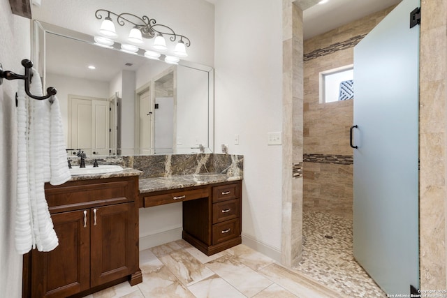 full bath featuring vanity and tiled shower