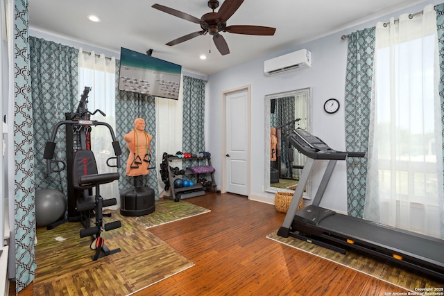 workout room with a ceiling fan, wood finished floors, a wall mounted AC, and recessed lighting