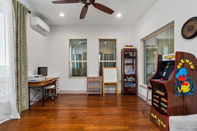 interior space featuring wood finished floors, ceiling fan, a wall unit AC, baseboards, and recessed lighting