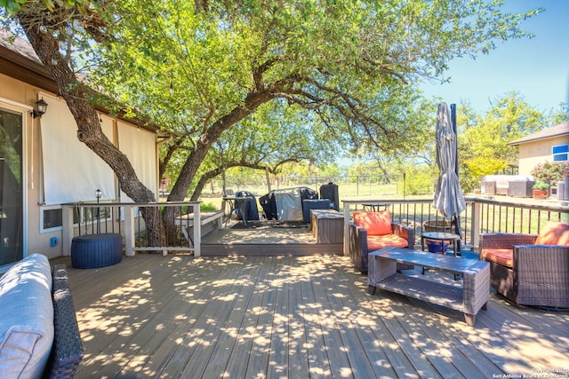 wooden terrace with an outdoor hangout area