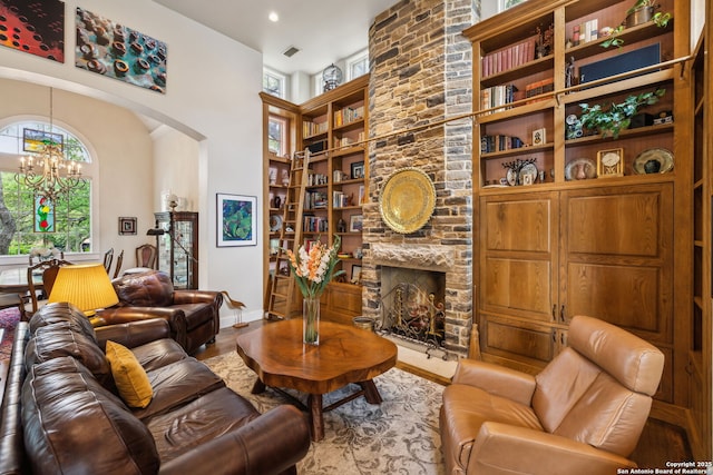 110 Turnberry Way, San Antonio, TX 78230 - living room with a chandelier, built in features, a high ceiling, a fireplace, and wood finished floors