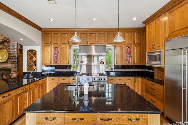110 Turnberry Way, San Antonio, TX 78230 - kitchen featuring built in appliances, under cabinet range hood, brown cabinetry, dark stone counters, and an island with sink