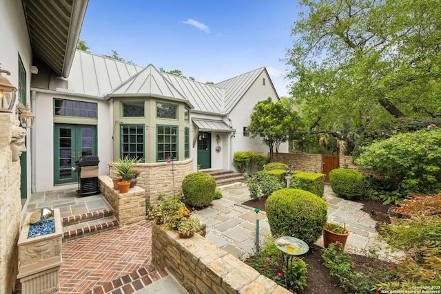 110 Turnberry Way, San Antonio, TX 78230 - view of front of house featuring a standing seam roof, metal roof, french doors, stucco siding, and stone siding