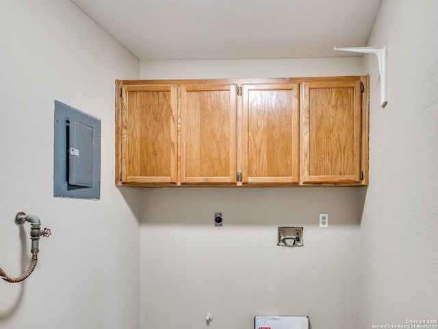 laundry area featuring electric panel, hookup for an electric dryer, hookup for a washing machine, cabinet space, and gas dryer hookup