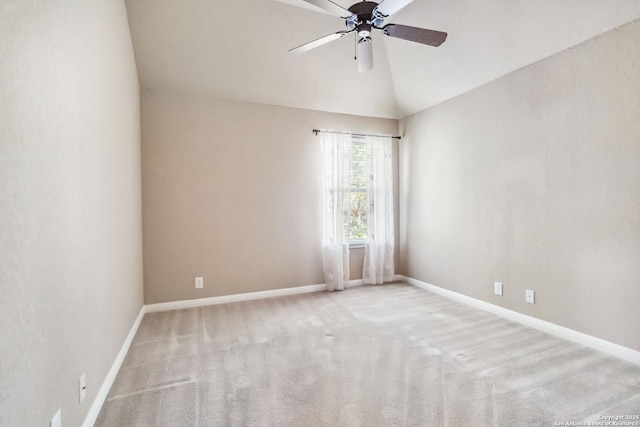 carpeted spare room featuring vaulted ceiling, baseboards, and ceiling fan