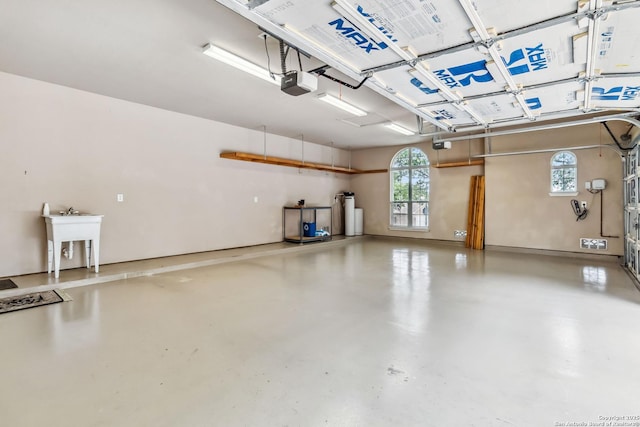 garage with a sink and a garage door opener