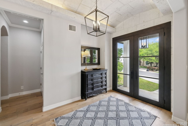 doorway to outside featuring vaulted ceiling, visible vents, light wood finished floors, and french doors