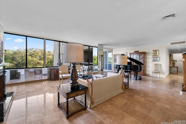 living area featuring a wall of windows, visible vents, a wealth of natural light, and ornamental molding