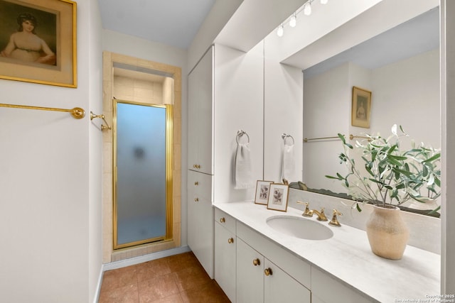 bathroom featuring vanity, tile patterned flooring, and a shower stall