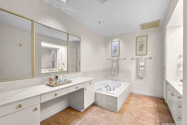 full bath with tile patterned flooring, visible vents, vanity, a bath, and baseboards