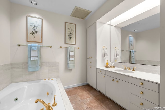 full bathroom with baseboards, vanity, and a tub with jets