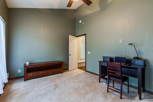 office featuring baseboards, carpet, ceiling fan, and high vaulted ceiling