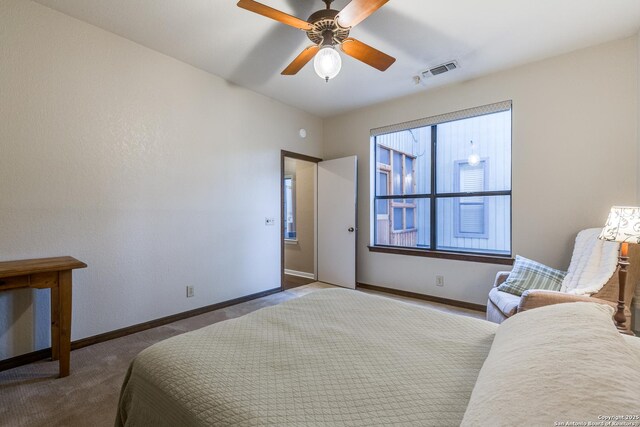 bedroom featuring baseboards, a ceiling fan, visible vents, and carpet flooring