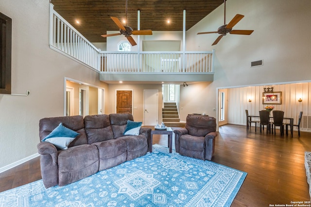 living area featuring visible vents, a ceiling fan, and high vaulted ceiling