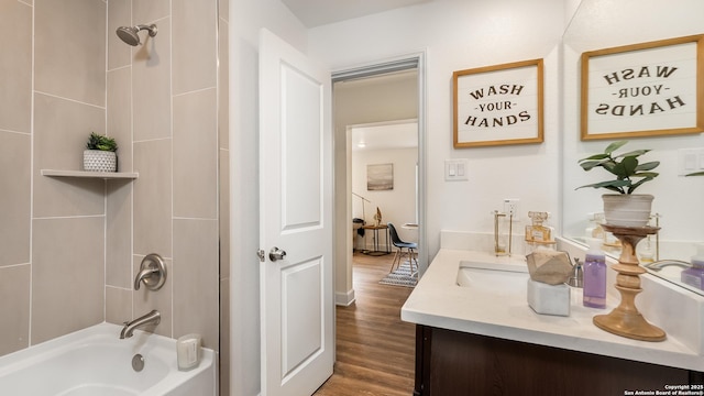 bathroom featuring bathing tub / shower combination, wood finished floors, and vanity