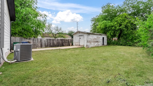 view of yard with fence, an outbuilding, a patio, and cooling unit