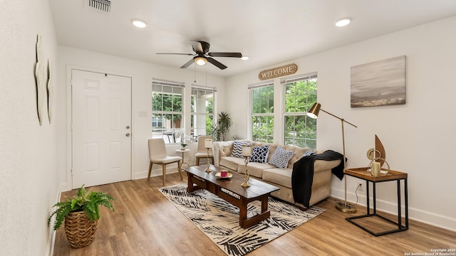 living area featuring recessed lighting, visible vents, a ceiling fan, baseboards, and light wood-style flooring