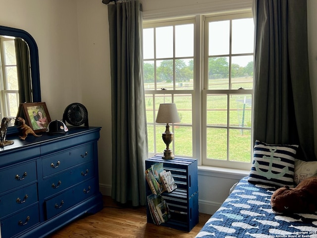 bedroom featuring dark wood finished floors and baseboards