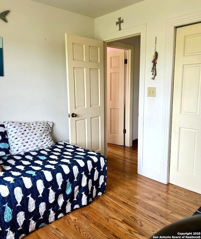 bedroom featuring wood finished floors