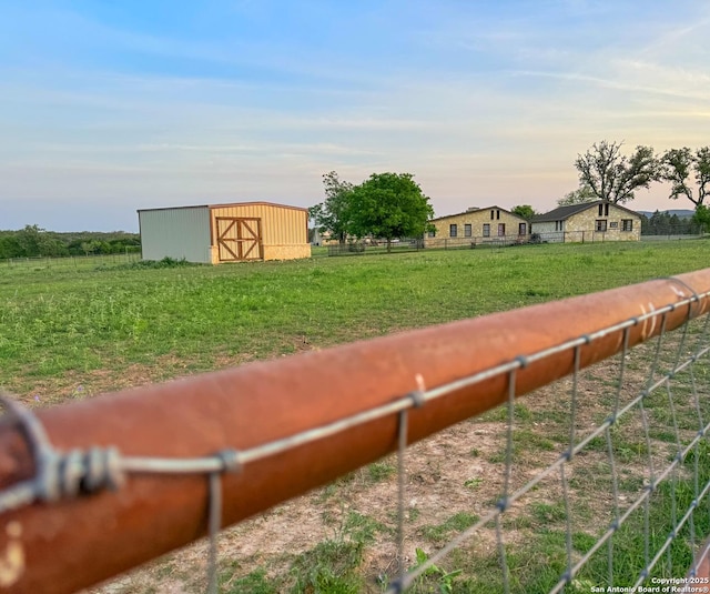 view of yard with an outdoor structure, an outbuilding, and fence