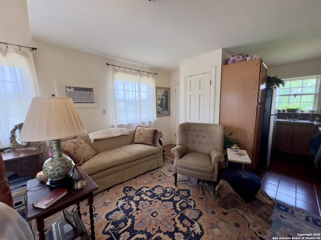 tiled living room with an AC wall unit and a sink