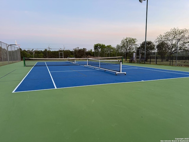 view of sport court with fence
