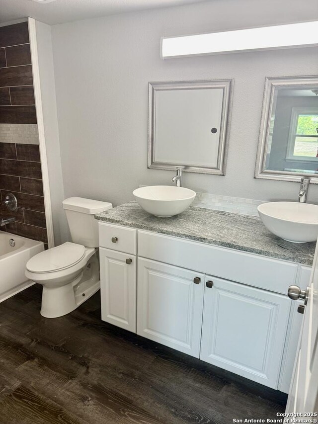 705 Short, Seguin, TX 78155 - full bath with double vanity, wood finished floors, toilet, and a sink