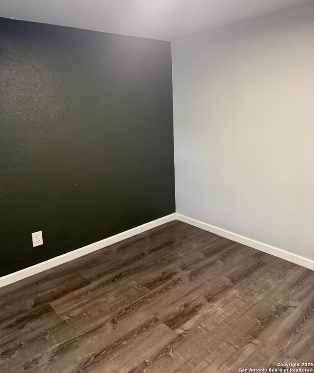 705 Short, Seguin, TX 78155 - empty room with baseboards and dark wood-style flooring