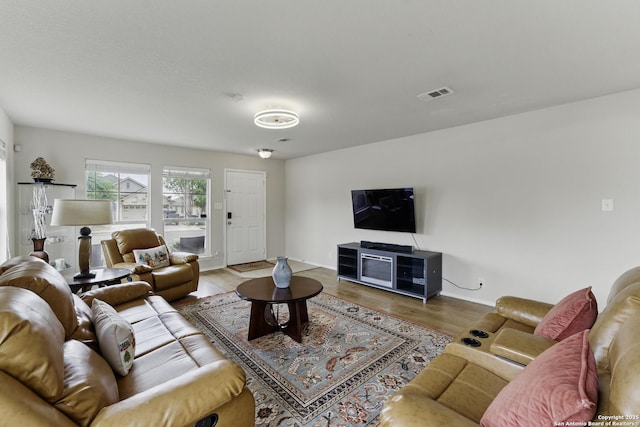 living room with wood finished floors and visible vents