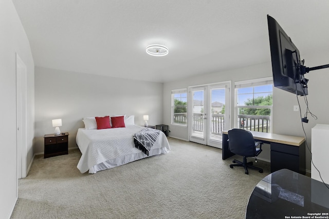 carpeted bedroom with baseboards and access to outside