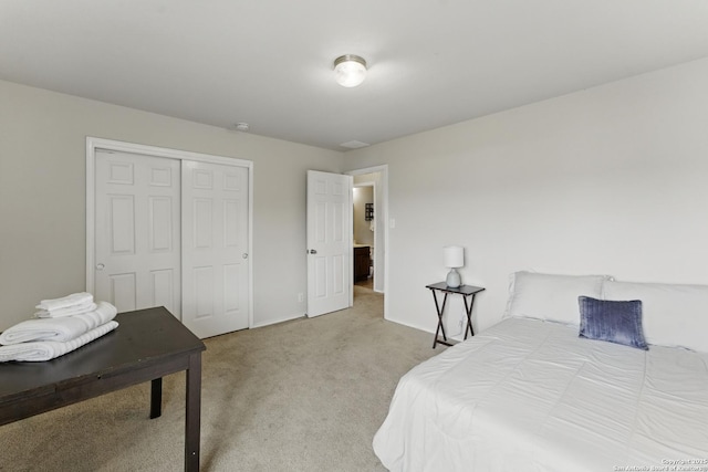 bedroom with carpet, a closet, and baseboards