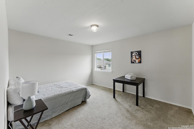 carpeted bedroom featuring visible vents and baseboards