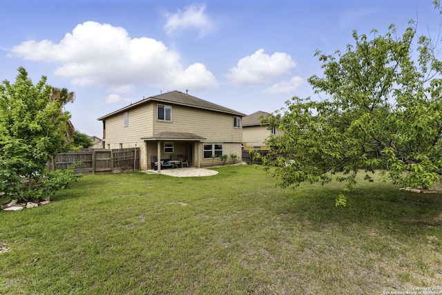 back of house featuring a patio area, a lawn, and a fenced backyard