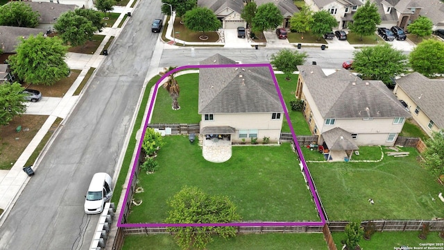 birds eye view of property with a residential view