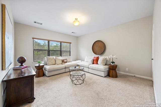 living area featuring visible vents, baseboards, and carpet flooring