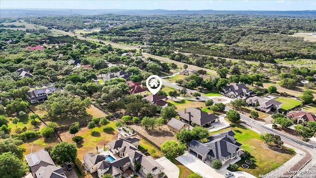 birds eye view of property featuring a residential view and a forest view
