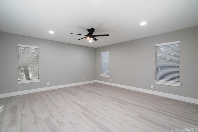 empty room with ceiling fan, baseboards, light wood finished floors, and recessed lighting