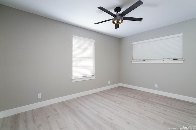 unfurnished room with baseboards, a ceiling fan, and wood finished floors