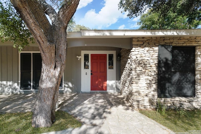 view of exterior entry with stone siding