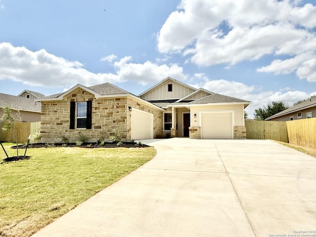 view of front of home with concrete driveway, stone siding, a shingled roof, an attached garage, and fence