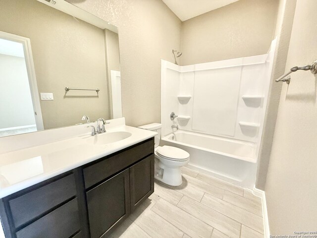 bathroom with toilet, vanity, and shower / tub combination