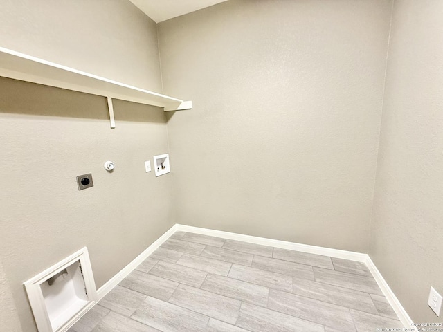 clothes washing area with electric dryer hookup, baseboards, laundry area, and hookup for a washing machine