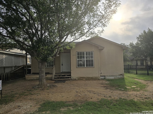 rear view of house featuring fence