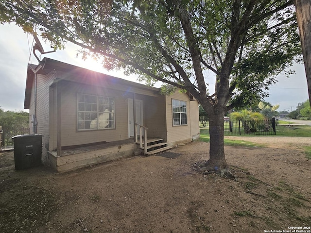 view of front of home featuring fence
