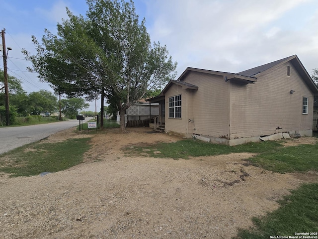 view of property exterior with crawl space and entry steps