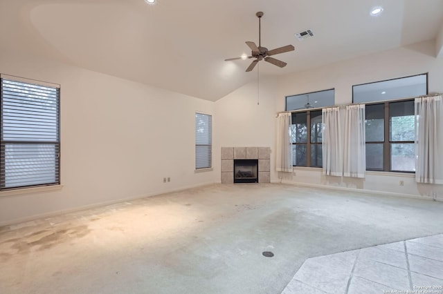 unfurnished living room featuring carpet, ceiling fan, a tiled fireplace, baseboards, and visible vents