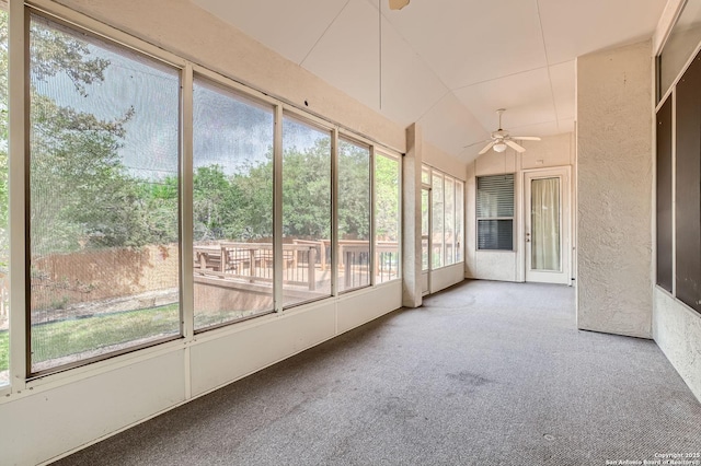 unfurnished sunroom with ceiling fan